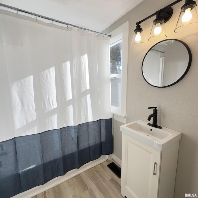 bathroom with vanity and wood-type flooring