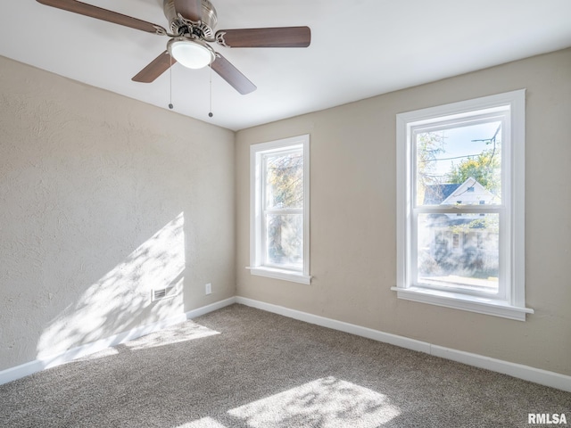 spare room with carpet floors and ceiling fan