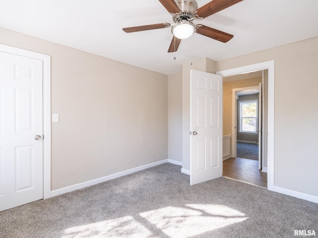 unfurnished bedroom with ceiling fan and carpet floors