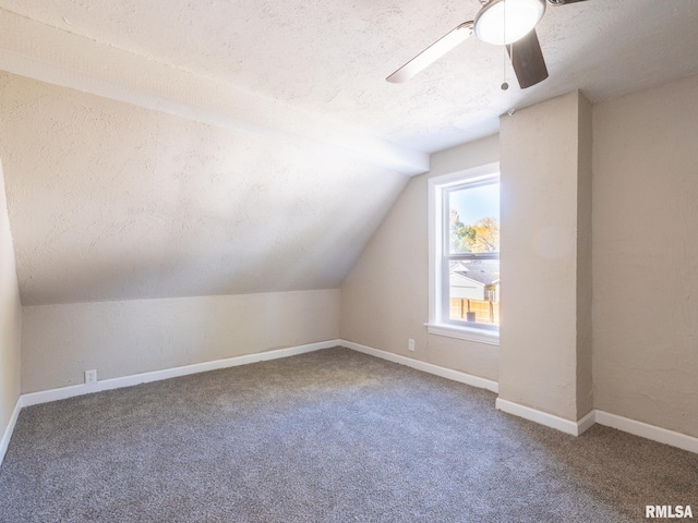 bonus room with carpet, ceiling fan, lofted ceiling, and a textured ceiling