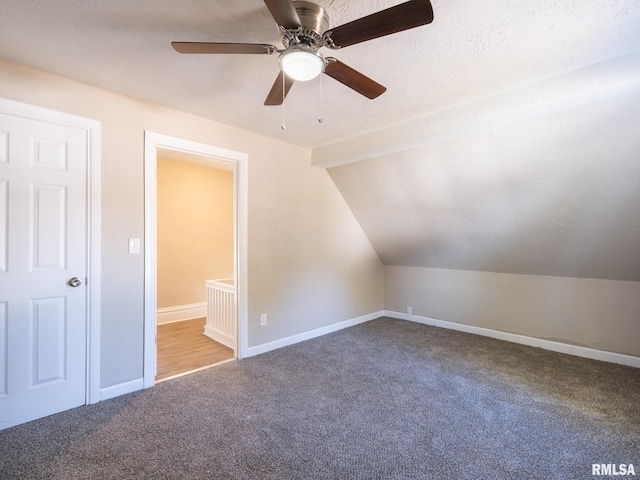 bonus room with a textured ceiling, ceiling fan, lofted ceiling, and carpet floors