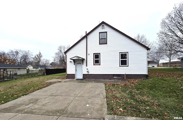 back of house with a yard