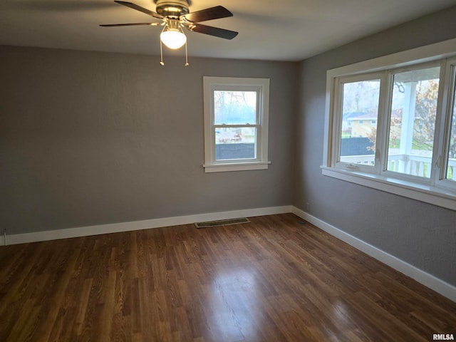 unfurnished room featuring dark hardwood / wood-style flooring and ceiling fan