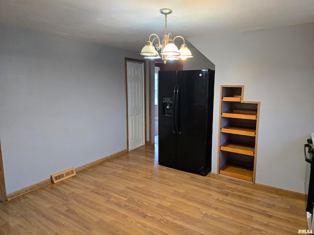 interior space with light hardwood / wood-style flooring and a notable chandelier