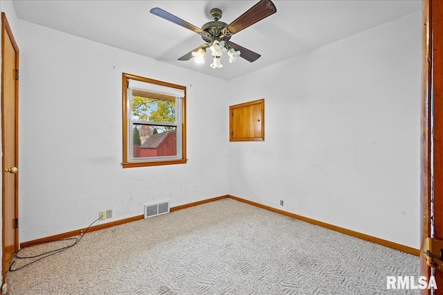 carpeted spare room with ceiling fan