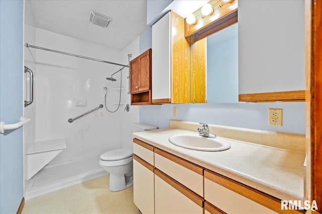 bathroom with vanity, toilet, and walk in shower