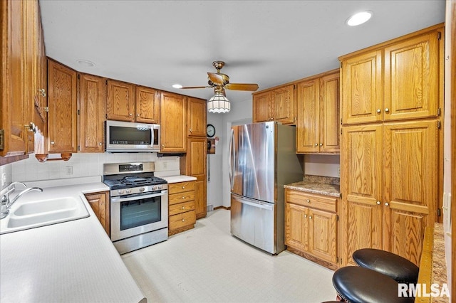 kitchen with ceiling fan, sink, and appliances with stainless steel finishes