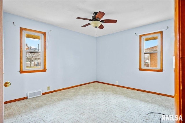 carpeted empty room featuring ceiling fan