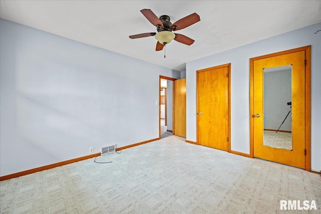 unfurnished bedroom featuring ceiling fan and light colored carpet