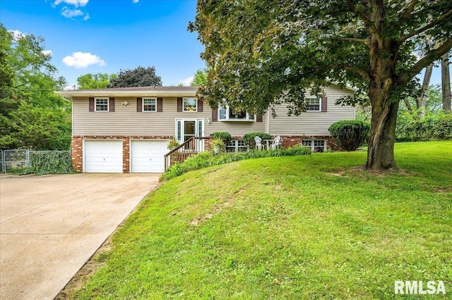 raised ranch with a garage and a front yard