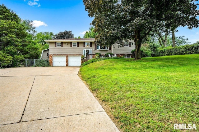 split foyer home featuring a garage and a front yard