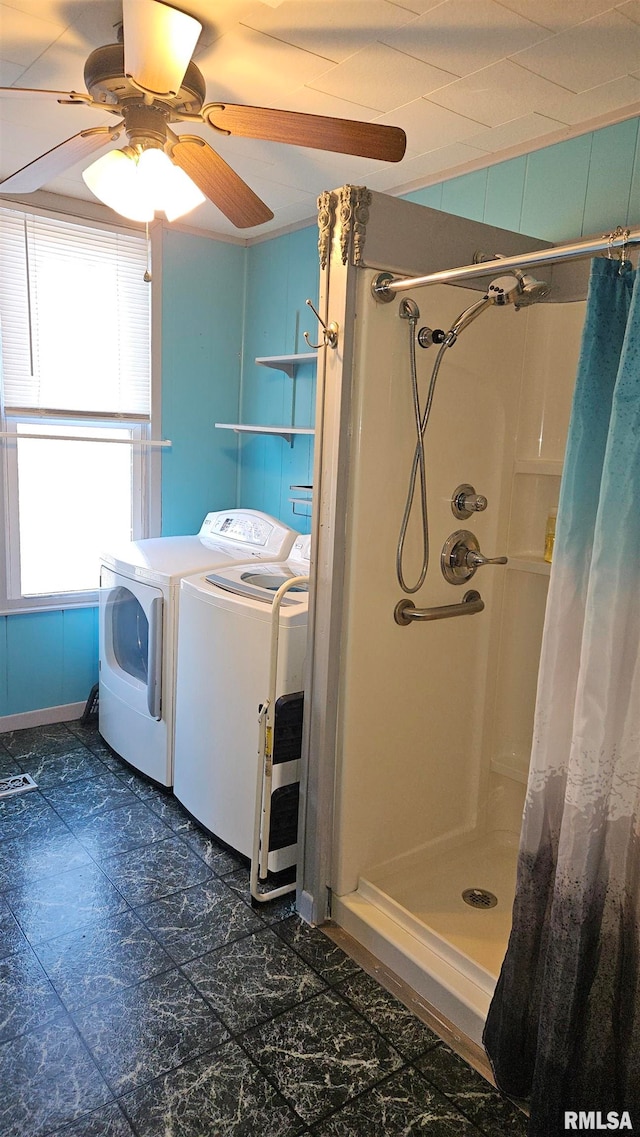 bathroom with a shower with curtain, ceiling fan, and washing machine and dryer