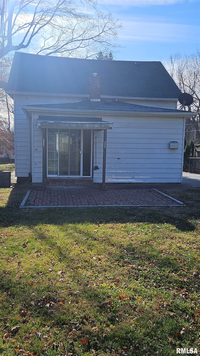 back of house with a lawn and a patio area