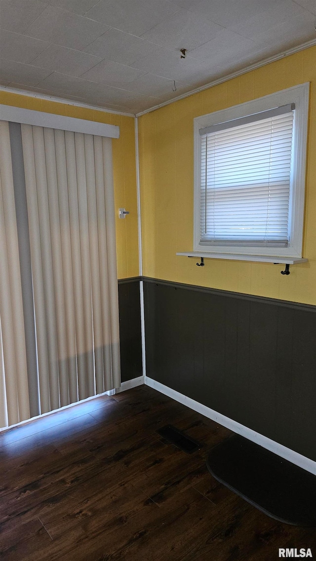 unfurnished room featuring dark wood-type flooring