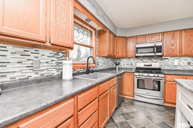 kitchen with backsplash, sink, and appliances with stainless steel finishes