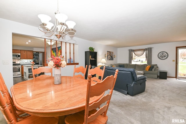 carpeted dining area featuring an inviting chandelier