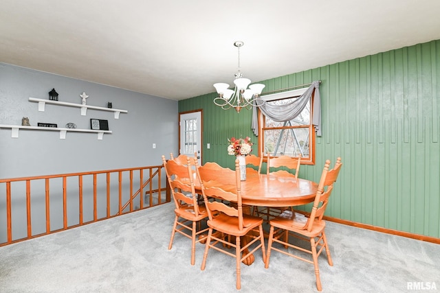 dining space featuring a chandelier and carpet flooring