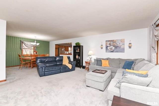 carpeted living room featuring a chandelier