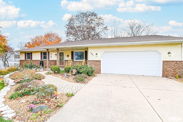 ranch-style home with covered porch and a garage