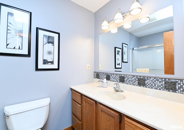 bathroom with decorative backsplash, a shower, vanity, and toilet