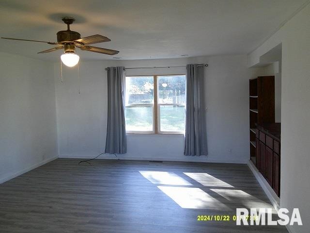 unfurnished room featuring ceiling fan and dark hardwood / wood-style flooring