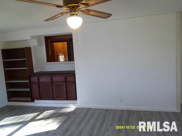 spare room featuring hardwood / wood-style floors and ceiling fan