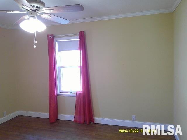 spare room featuring dark hardwood / wood-style flooring, ceiling fan, and crown molding