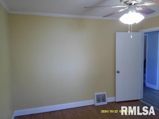 empty room featuring ceiling fan, dark hardwood / wood-style flooring, and crown molding