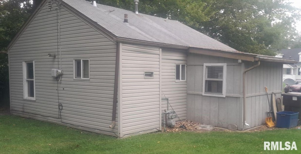 view of side of home featuring a lawn