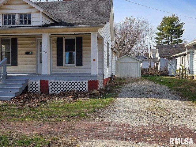 view of front of home with an outbuilding, a porch, and a garage