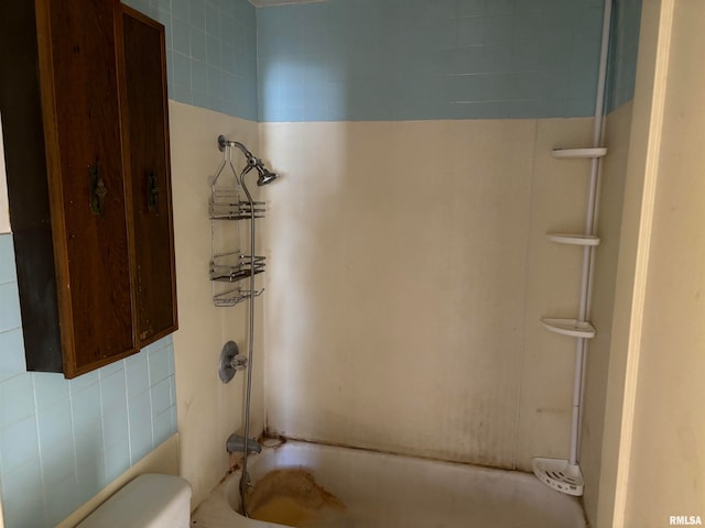 bathroom with shower / bathtub combination and toilet