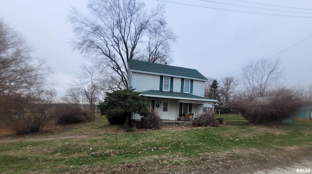 view of front of home with covered porch and a front lawn