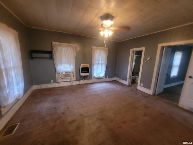 unfurnished bedroom with heating unit, cooling unit, ornamental molding, and dark colored carpet