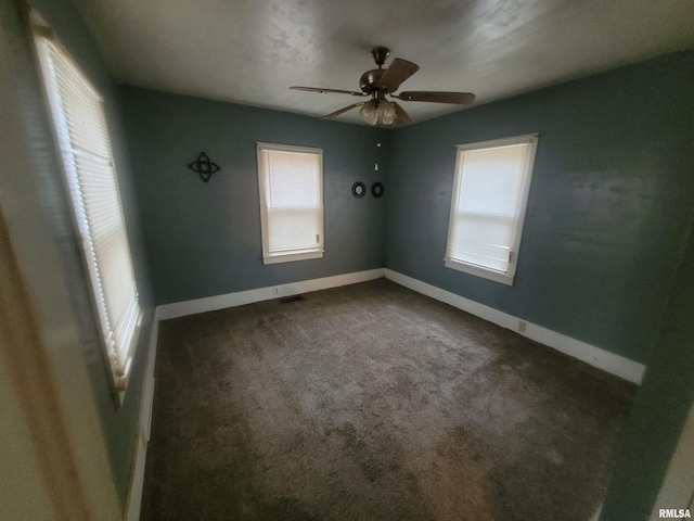 carpeted spare room featuring ceiling fan