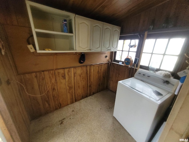 laundry room featuring wooden walls, cabinets, wooden ceiling, and washer / clothes dryer