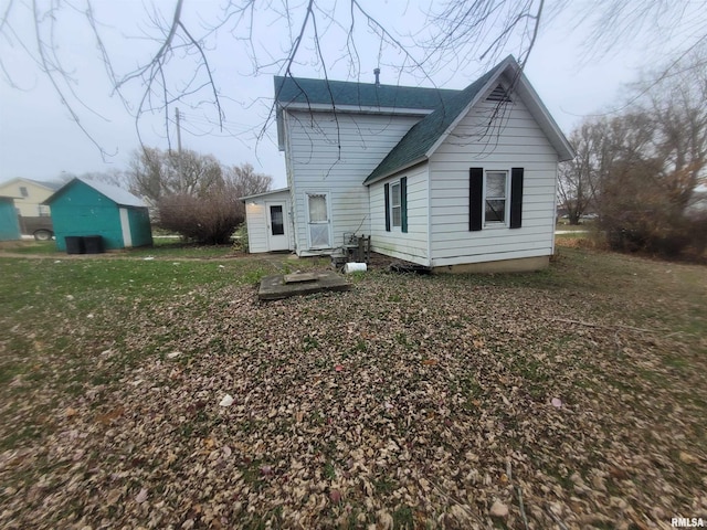 rear view of house featuring a yard