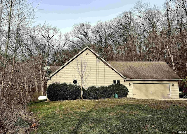 view of side of home with a garage and a yard