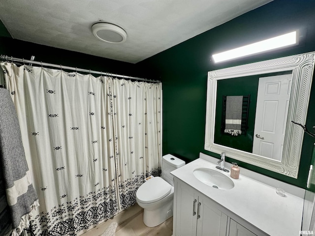 bathroom featuring vanity, toilet, and walk in shower