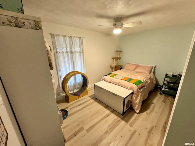 bedroom with ceiling fan and light wood-type flooring