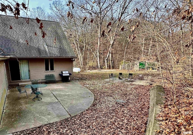 view of yard with a fire pit and a patio area