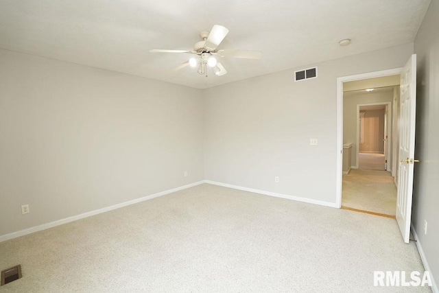 spare room featuring ceiling fan and light colored carpet