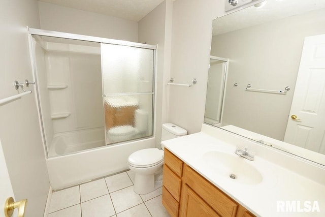 full bathroom with tile patterned floors, vanity, toilet, and bath / shower combo with glass door