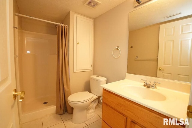 bathroom featuring a shower with shower curtain, tile patterned floors, vanity, a textured ceiling, and toilet