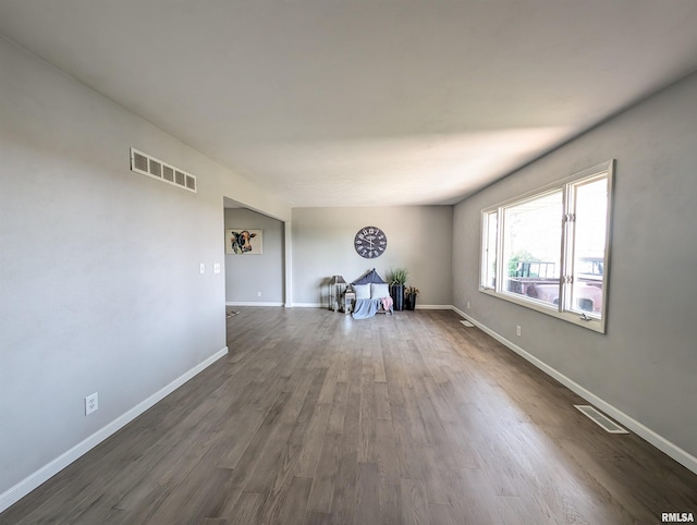 spare room with dark wood-type flooring