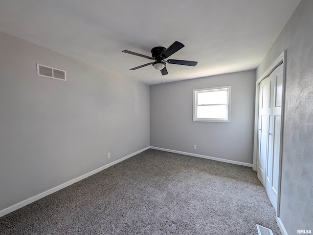 unfurnished bedroom with ceiling fan, carpet flooring, visible vents, and baseboards