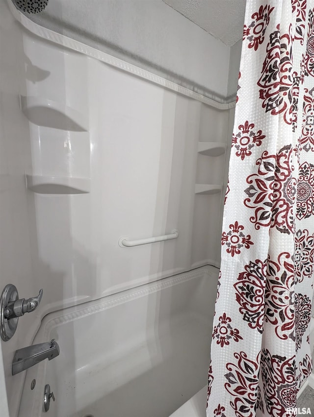 bathroom featuring shower / bath combination with curtain and a textured ceiling