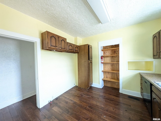 kitchen with visible vents, dishwashing machine, dark wood-style floors, light countertops, and a textured ceiling