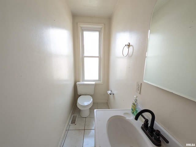 bathroom featuring tile patterned floors, a wealth of natural light, sink, and toilet