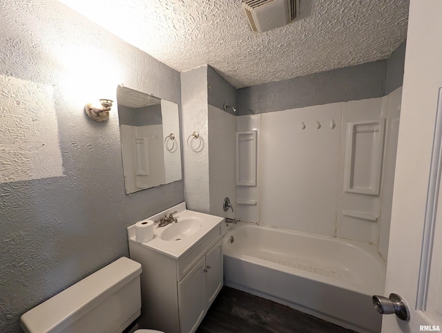 full bath with a textured wall, toilet, visible vents, vanity, and  shower combination