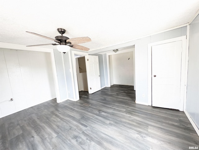 unfurnished bedroom featuring a textured ceiling, a closet, wood finished floors, and a ceiling fan